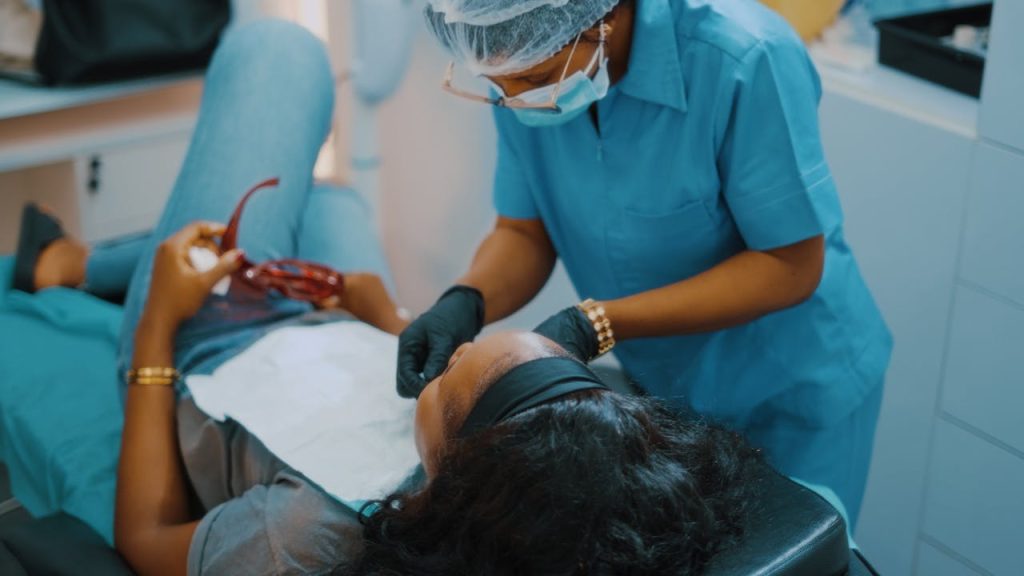 Dental professional attending to a patient in a clinic in Lagos, Nigeria.